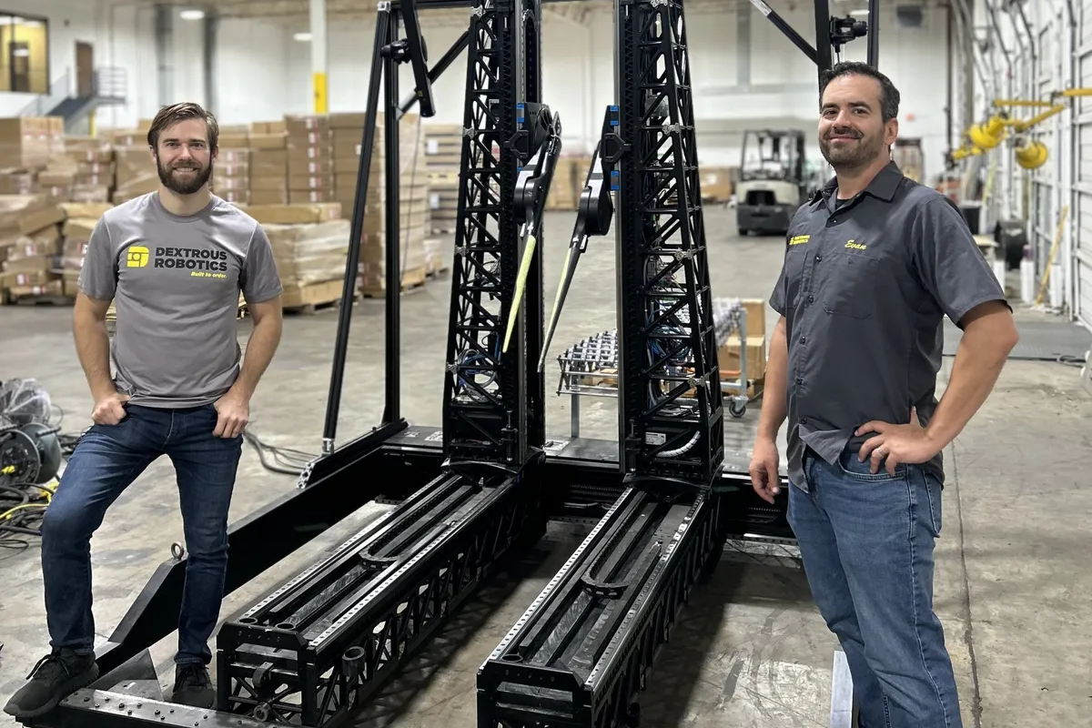 Dextrous Robotics cofounders Sam Zapolsky [left] and Evan Drumwright show off their latest warehouse robot.